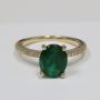 Oval Cut Emerald Prong Set Ring With Round Diamonds