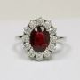 Oval Cut Ruby Prong Set Halo Ring With Round Diamonds
